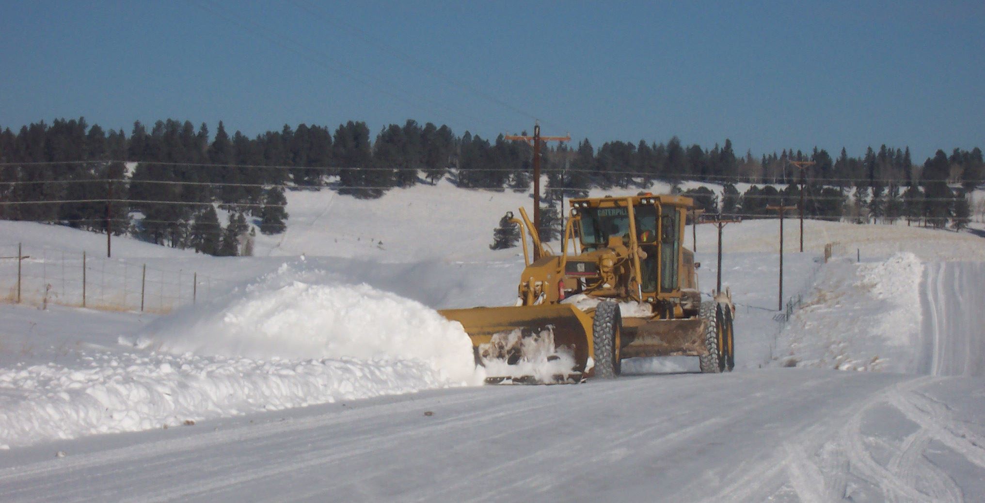 graphic image of road grader plowing snow