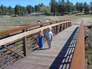 Two Girls Smiling on a Bridge at Four Mile Scenic Park