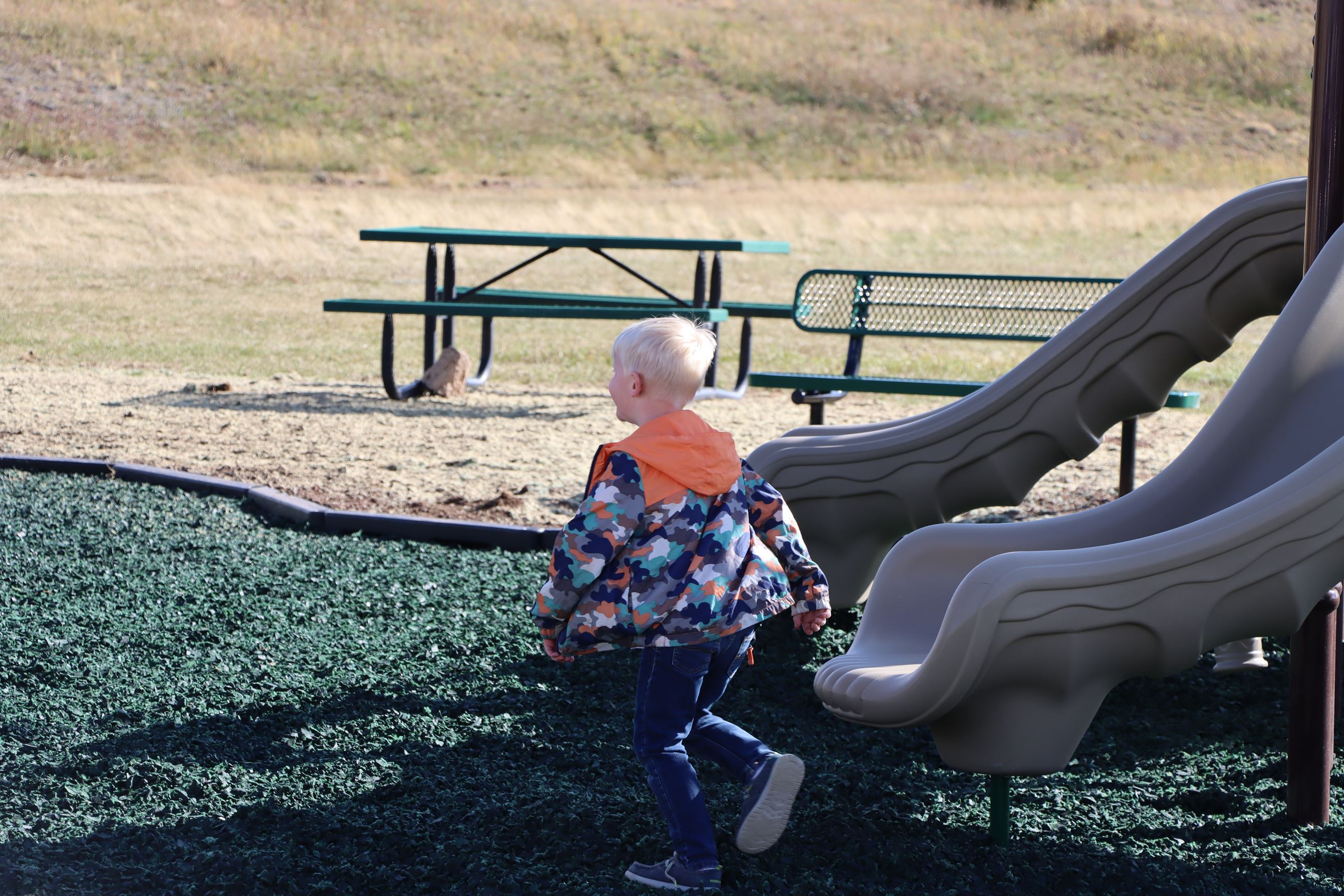 boy playing on new playground equipment